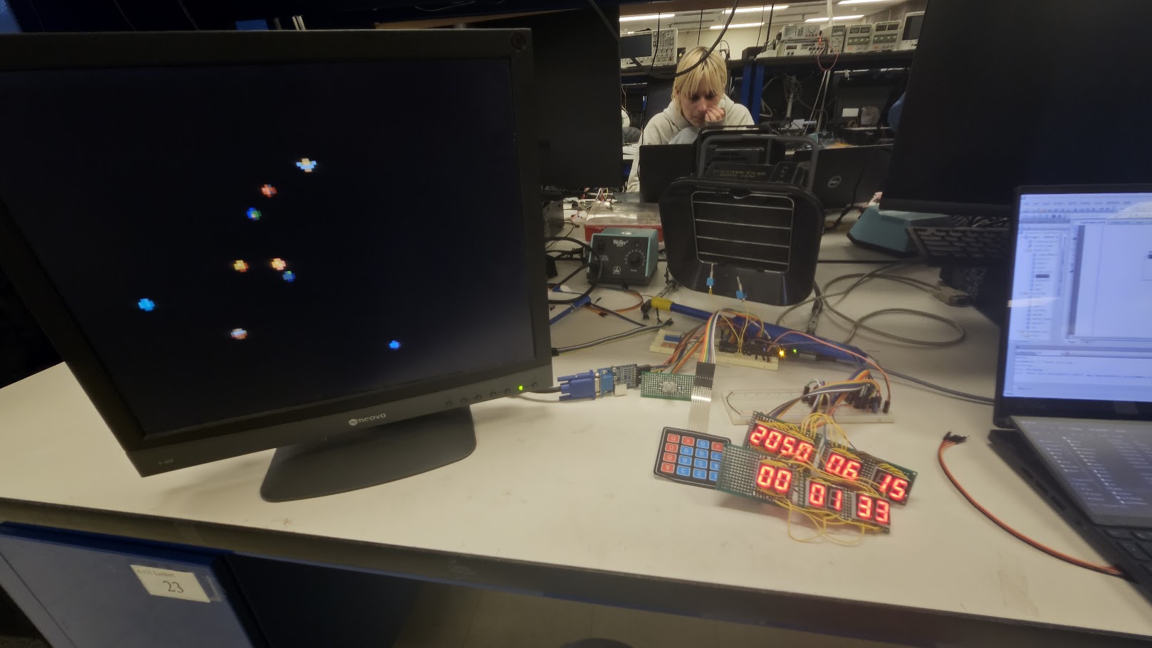 Complete PSoC orbit-simulator bench setup with VGA monitor, keypad, and seven-segment displays